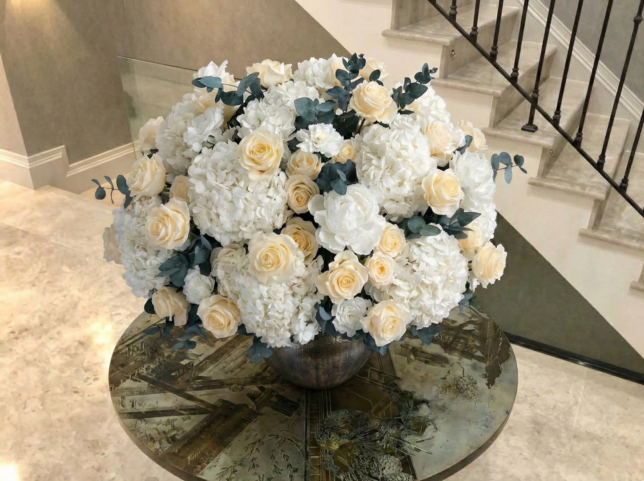 Floral arrangement on a round table in a home setting